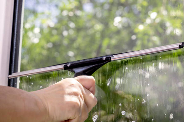 Cleaning a Window with squeegee